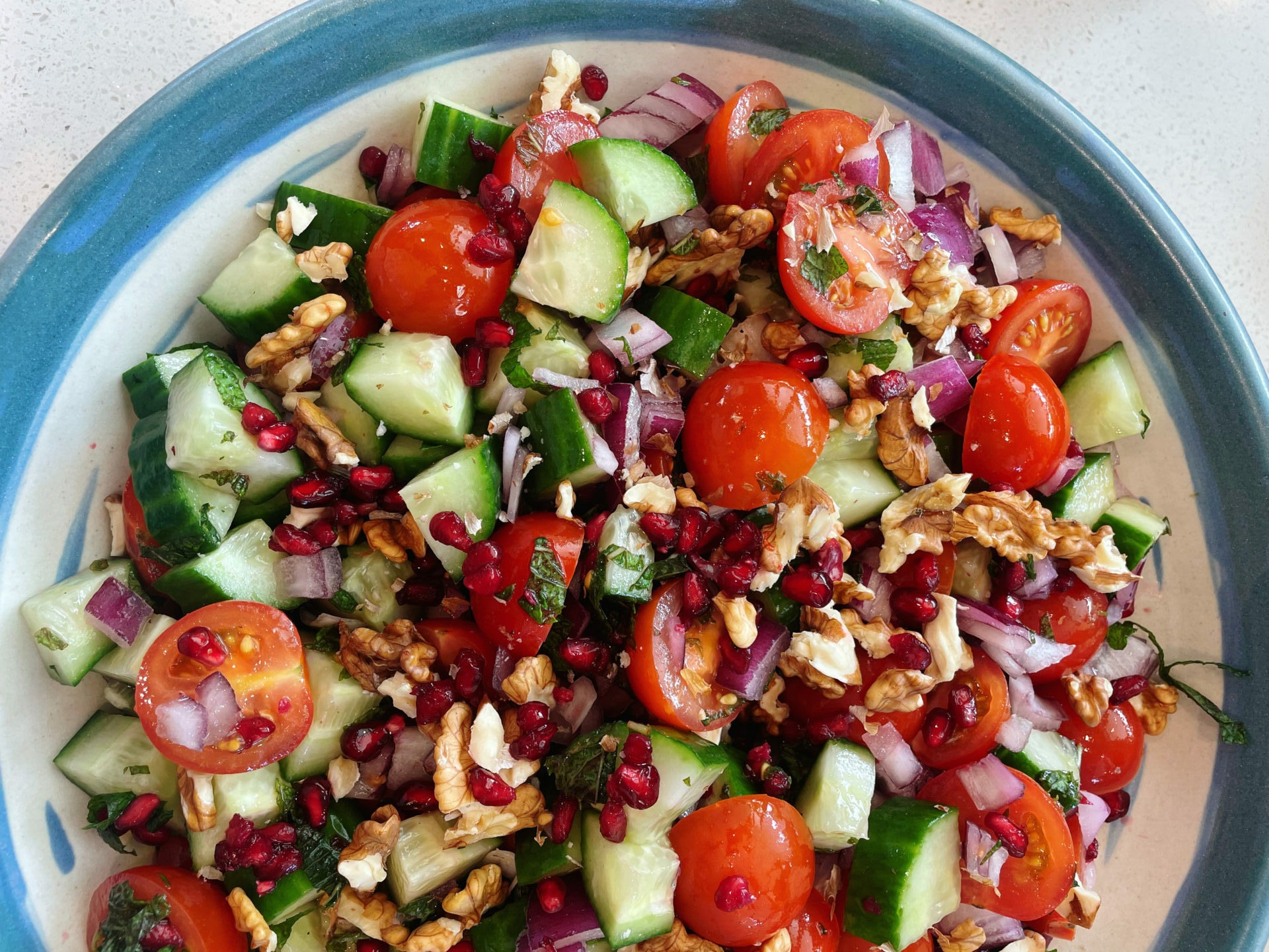 Tomato salad with cucumber, walnuts and pomegranate
